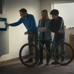 Family checking home battery system in UK garage