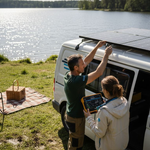Couple installing solar panels on campervan
