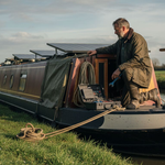 Boat owner inspecting solar panels dockside