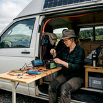 Woman assembling solar battery system in campervan
