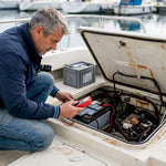 Boat owner inspecting marine battery in engine