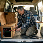Campervan owner installing lithium battery
