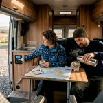 Couple using campervan off-grid power inside van