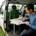Man checks campervan power system in field
