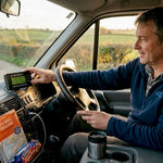 Man checking battery monitor in camper van