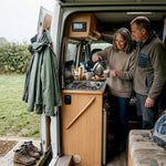 Couple using off-grid power in campervan