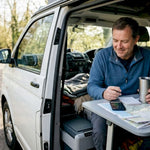 Man checking Bluetooth battery in camper van