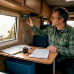 Camper van owner checking battery monitor