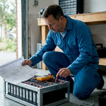 Technician checking lithium batteries in workshop