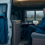 Man checks campervan battery monitor tablet