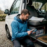 Man troubleshooting campervan power battery system