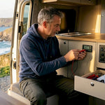 Camper van owner checking battery monitor