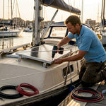 Technician installing solar panel on boat deck