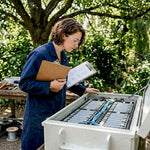 Engineer inspecting battery enclosure in lab