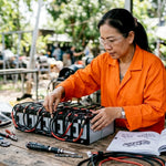 Engineer inspecting modular battery bank in workshop