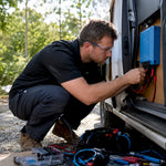 Technician installing DC-DC charger in van